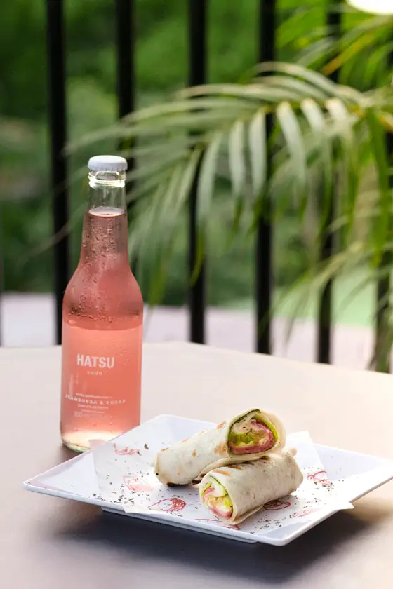 Wraps acompañados de soda rosada en terraza